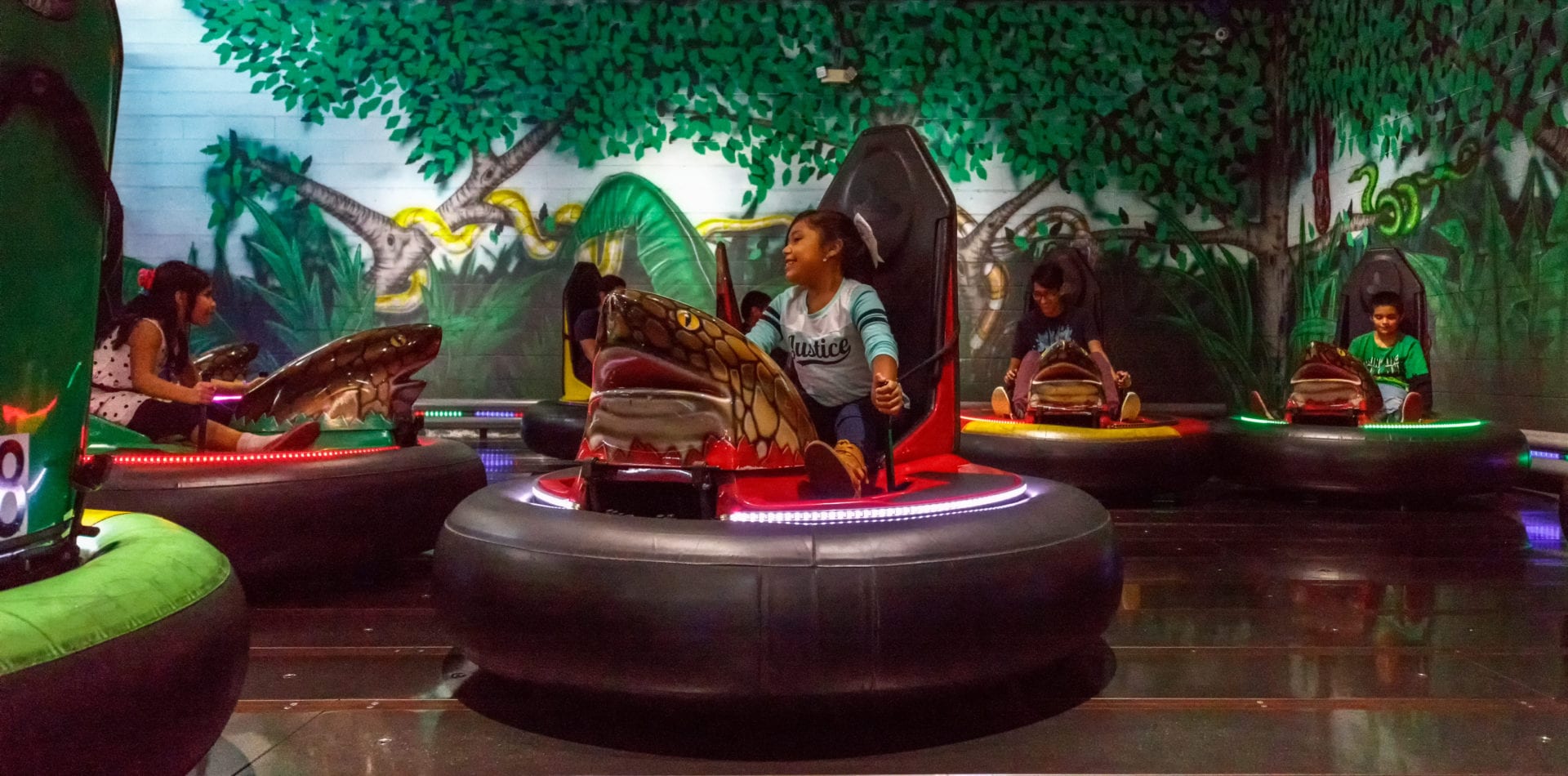 Kid smiling playing in a bumper car